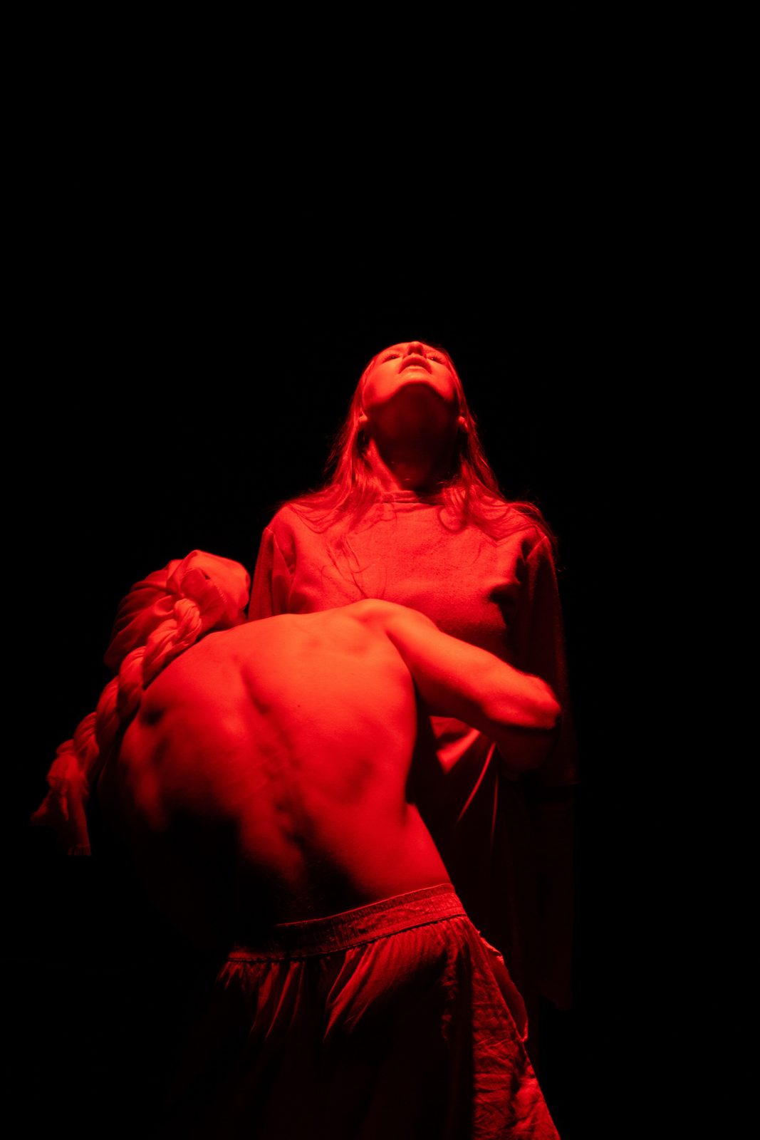 Performer lifted in red light