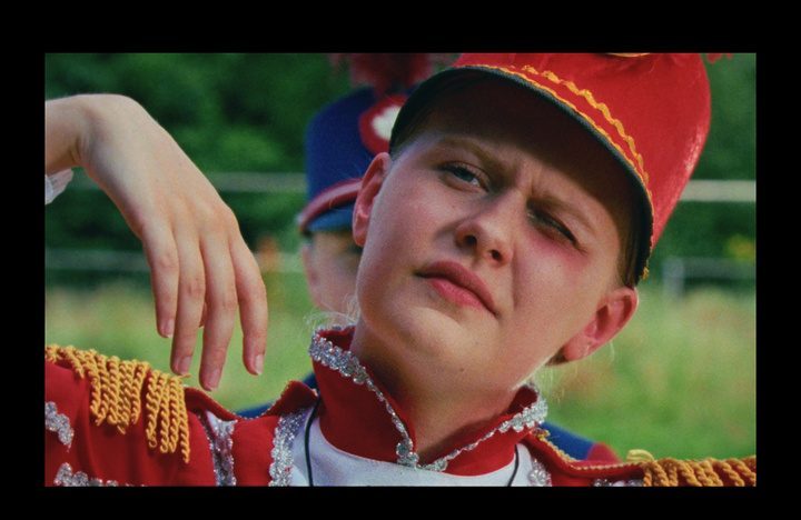 Still of a boy in a red band hat