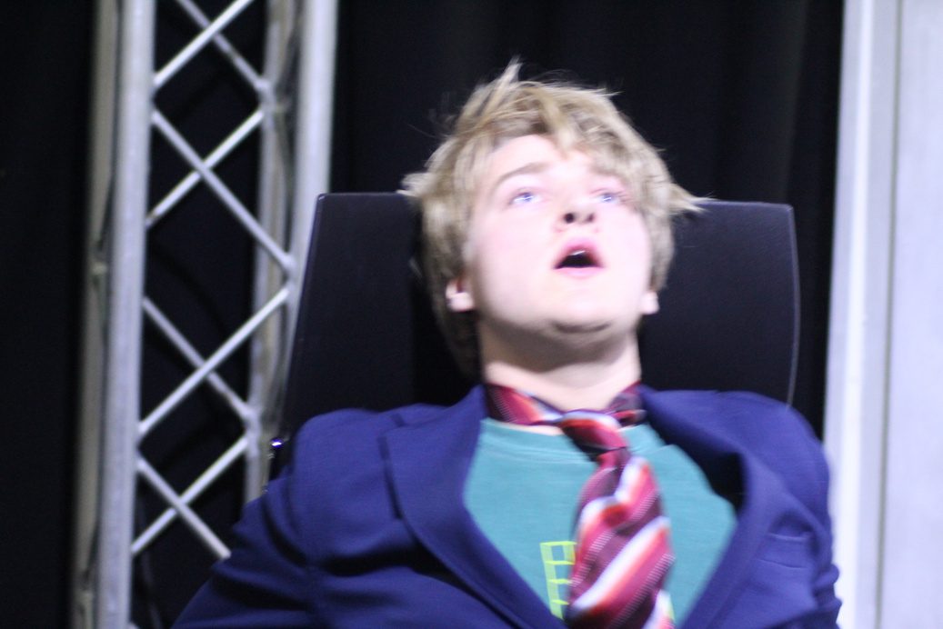 Performer under a truss, looking up