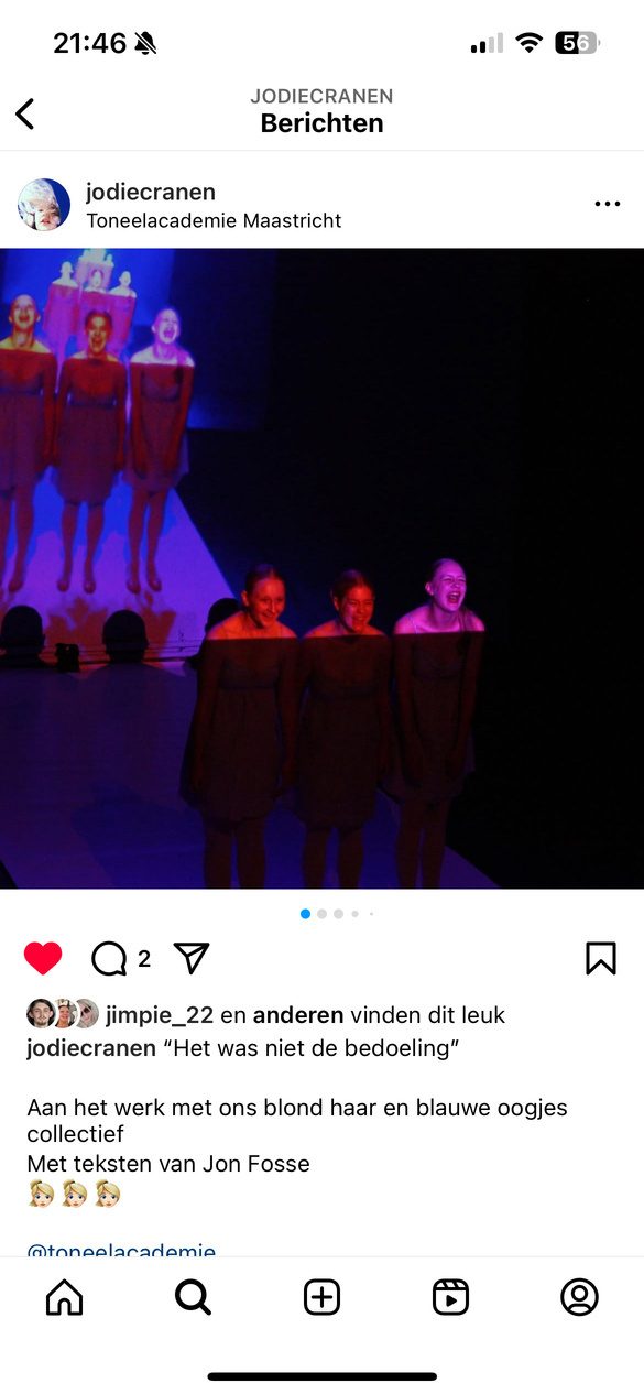 Three performers on a blue-lit stage