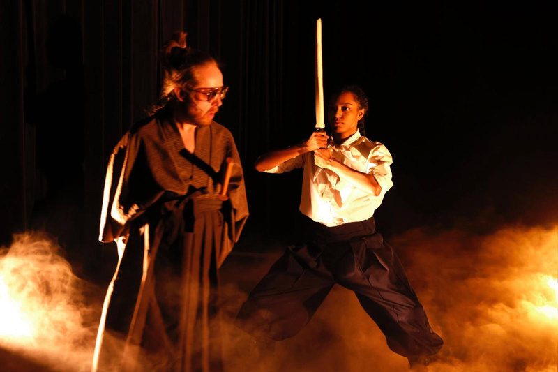Sword fight in smoke and orange light