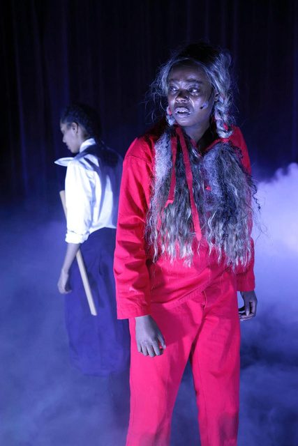 Performer in red in blue haze