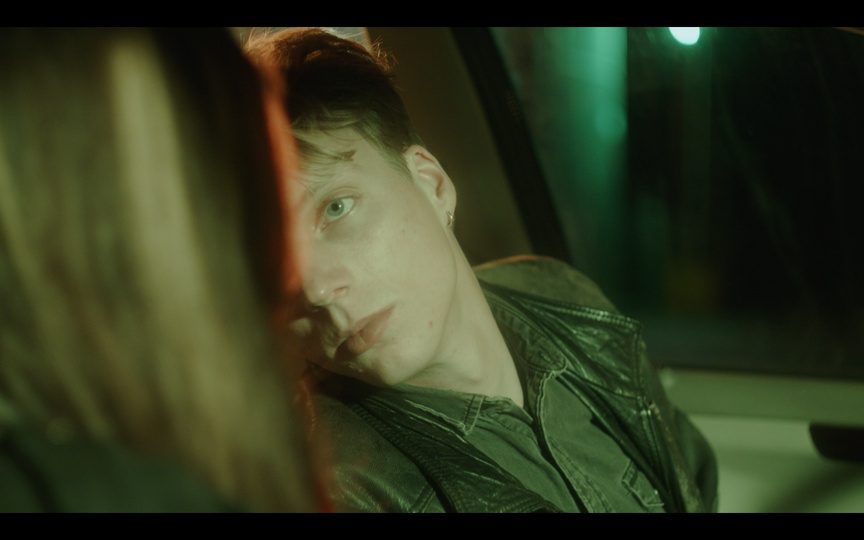 Still: a man in green light